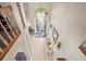 Inviting foyer with tiled floors, a modern chandelier, and glass double doors at 18917 Avenue Biarritz, Lutz, FL 33558