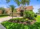 Beautiful front exterior with a paver driveway, 2-car garage, landscaping, and tile roof at 18917 Avenue Biarritz, Lutz, FL 33558