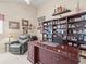 Comfortable home office featuring a large desk, a bookshelf, and decor at 18917 Avenue Biarritz, Lutz, FL 33558
