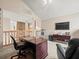 Bright home office with a large desk, a ceiling fan, and a view of the entry hall at 18917 Avenue Biarritz, Lutz, FL 33558