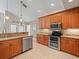 Bright kitchen featuring stainless steel appliances, modern cabinetry, and granite countertops at 18917 Avenue Biarritz, Lutz, FL 33558