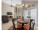 Cozy living and dining area featuring hardwood floors, vaulted ceilings, and contemporary decor at 18917 Avenue Biarritz, Lutz, FL 33558