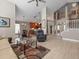 Bright, open-plan living room featuring high ceilings, neutral tones, and seamless flow to the kitchen at 18917 Avenue Biarritz, Lutz, FL 33558