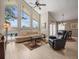 Bright living room with high ceilings, large windows, and comfortable seating overlooking the pool at 18917 Avenue Biarritz, Lutz, FL 33558