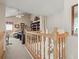 Cozy loft with plush carpeting, a ceiling fan, and a view of the living room at 18917 Avenue Biarritz, Lutz, FL 33558