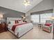 Relaxing main bedroom with ceiling fan, vaulted ceiling, and large windows at 18917 Avenue Biarritz, Lutz, FL 33558