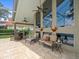 Spacious covered patio with comfortable seating and a view of the lush garden and serene lake at 18917 Avenue Biarritz, Lutz, FL 33558