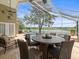Inviting screened-in pool area with elegant outdoor seating, lake views, perfect for entertaining at 18917 Avenue Biarritz, Lutz, FL 33558