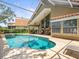 Enclosed pool with tiled deck and covered seating area perfect for entertaining at 18917 Avenue Biarritz, Lutz, FL 33558