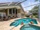 Stunning screened-in pool with spa, fish decor, and lake views, an oasis of outdoor relaxation and entertainment at 18917 Avenue Biarritz, Lutz, FL 33558