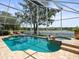 Sparkling screened-in pool with lake view, lush landscaping, and a tranquil outdoor space for relaxation at 18917 Avenue Biarritz, Lutz, FL 33558