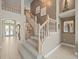 Elegant staircase featuring carpeted steps and wooden railings, leading to the upper level at 18917 Avenue Biarritz, Lutz, FL 33558