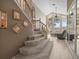 Well-lit staircase featuring carpeted steps, wooden railings and an open view of the living area at 18917 Avenue Biarritz, Lutz, FL 33558