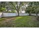 Backyard with privacy fence and mature trees, ideal for outdoor activities and relaxation at 2010 Groveland Rd, Palm Harbor, FL 34683