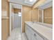 Bright bathroom featuring a vanity, mirror, and shower with white tiling at 2010 Groveland Rd, Palm Harbor, FL 34683