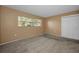 This bedroom features a window and neutral walls and carpeting at 2010 Groveland Rd, Palm Harbor, FL 34683