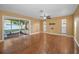 Spacious living room with a ceiling fan, wood flooring, and access to a screened in porch at 2010 Groveland Rd, Palm Harbor, FL 34683