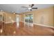 Bright living room with wood flooring, ceiling fans, and sliding glass doors to the porch at 2010 Groveland Rd, Palm Harbor, FL 34683