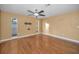 Open living room with wood flooring, offering a wall mount and window access to natural light at 2010 Groveland Rd, Palm Harbor, FL 34683