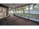View from screened patio overlooking backyard and showcasing seamless indoor-outdoor living at 2010 Groveland Rd, Palm Harbor, FL 34683