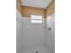 This bathroom shower has white tile walls at 2010 Groveland Rd, Palm Harbor, FL 34683