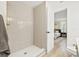 Bathroom features a tiled shower, hardwood flooring, and a view into the bedroom at 2017 Rebecca Dr, Clearwater, FL 33764