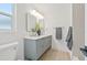 Modern bathroom boasts double sinks, decorative mirrors, updated fixtures, and a glass-enclosed shower at 2017 Rebecca Dr, Clearwater, FL 33764