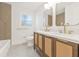 Bathroom featuring a double sink vanity, modern fixtures, and decorative tile at 2017 Rebecca Dr, Clearwater, FL 33764