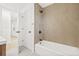 Modern bathroom featuring stylish geometric-patterned tile surround the bathtub, with a shower head, and bronze fixtures at 2017 Rebecca Dr, Clearwater, FL 33764
