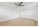 Spacious bedroom featuring a ceiling fan and a double door closet with light-colored wood floors at 2017 Rebecca Dr, Clearwater, FL 33764