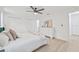 Bright bedroom features light hardwood flooring, ceiling fan, and a spacious walk-in closet at 2017 Rebecca Dr, Clearwater, FL 33764