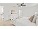 Bright bedroom boasts light hardwood flooring, a ceiling fan, and a walk-in closet at 2017 Rebecca Dr, Clearwater, FL 33764