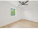 Bedroom featuring hardwood floors, a large window, modern AC unit, and a closet at 2017 Rebecca Dr, Clearwater, FL 33764