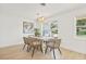 Bright dining area with modern decor, natural light, and wood floors for intimate gatherings at 2017 Rebecca Dr, Clearwater, FL 33764