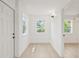 Entryway featuring hardwood floors, bright windows, and updated fixtures at 2017 Rebecca Dr, Clearwater, FL 33764