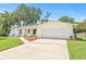 Inviting exterior view of a home with a manicured front lawn, fresh landscaping, and a brick facade at 2017 Rebecca Dr, Clearwater, FL 33764
