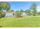 Well-manicured front yard showcasing healthy green grass, a large cactus, and other landscaping around the property at 2017 Rebecca Dr, Clearwater, FL 33764
