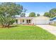 Charming single-story home with a well-maintained lawn and landscaping featuring a decorative cactus at 2017 Rebecca Dr, Clearwater, FL 33764