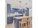 Modern kitchen with navy blue cabinetry, stainless steel appliances, and an island with seating for casual dining at 2017 Rebecca Dr, Clearwater, FL 33764