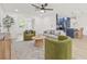 Bright living room with a ceiling fan and direct access to the kitchen, creating a welcoming atmosphere at 2017 Rebecca Dr, Clearwater, FL 33764