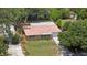 Charming single-story home features a red tile roof, garage, a well-manicured lawn, and mature trees at 2333 Indigo Dr, Clearwater, FL 33763