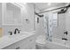 Bathroom features a marble vanity, black hardware and decorative shower curtain at 2333 Indigo Dr, Clearwater, FL 33763