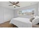 Bedroom with wood-look flooring, a ceiling fan, and a view of the exterior from the window at 2333 Indigo Dr, Clearwater, FL 33763