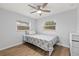 Bedroom with wood-look floors, a ceiling fan, natural light, and neutral paint at 2333 Indigo Dr, Clearwater, FL 33763