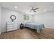 Bedroom featuring wood-look flooring, neutral paint, a ceiling fan, and ample natural light at 2333 Indigo Dr, Clearwater, FL 33763