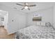 Bright bedroom features a ceiling fan, wood-look floors, natural light, and an ensuite bathroom at 2333 Indigo Dr, Clearwater, FL 33763