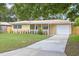 Beautiful single-story home with a welcoming front porch and well-maintained landscaping at 2333 Indigo Dr, Clearwater, FL 33763