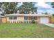 Charming single story home featuring a light color scheme, a well maintained lawn, and an attached garage at 2333 Indigo Dr, Clearwater, FL 33763