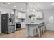 Updated kitchen with white cabinetry, stainless steel appliances, pendant lighting, and counter seating at 2333 Indigo Dr, Clearwater, FL 33763