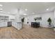 Open-concept kitchen featuring white cabinets, stainless steel appliances and an island overlooking the dining area at 2333 Indigo Dr, Clearwater, FL 33763
